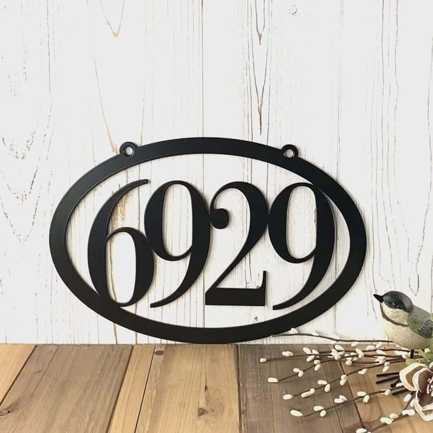 Video of hanging oval metal house number sign, in matte black powder coat.