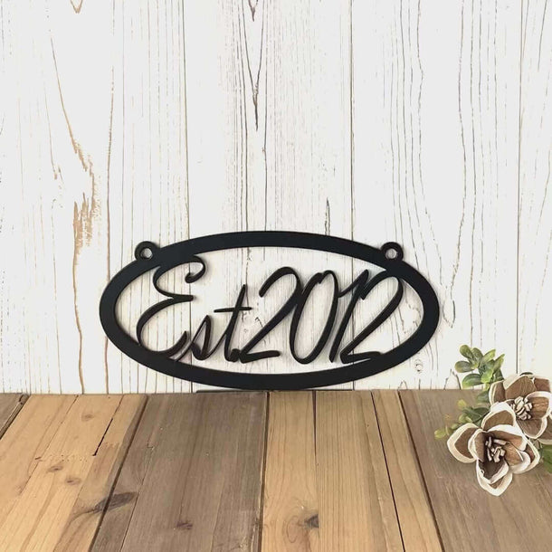 Video of hanging oval family established year metal sign, in matte black powder coat.