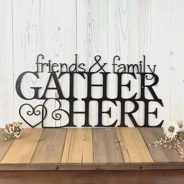Video of Friends and Family Gather Here metal wall art with two cute hearts, in matte black powder coat.