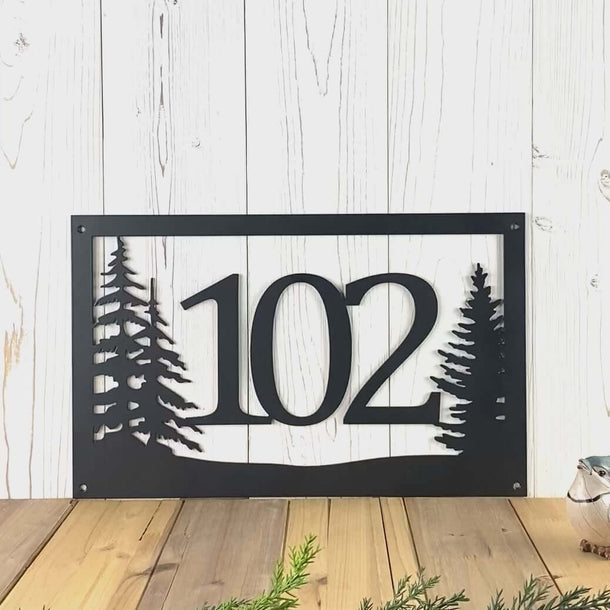 Video of rectangular metal house number sign with pine trees, in matte black powder coat.