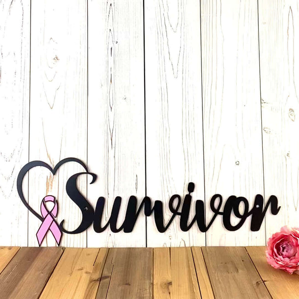 Video of Breast cancer survivor metal wall art with heart and pink ribbon, in matte black powder coat.