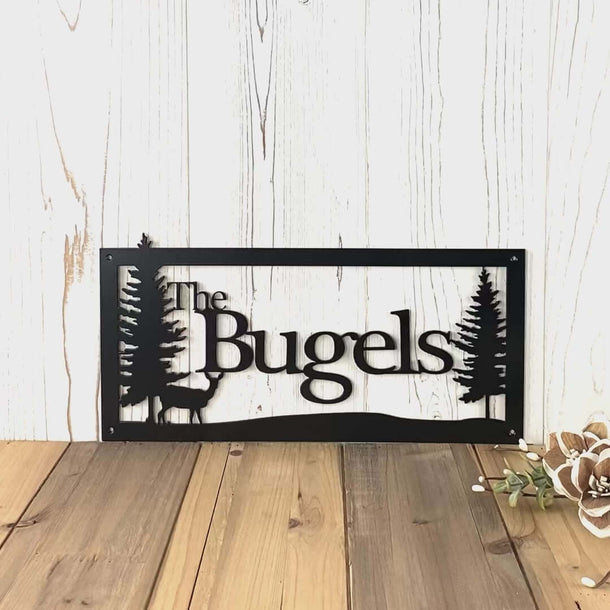 Video of custom family name metal sign with doe deer and pine trees, in matte black powder coat.