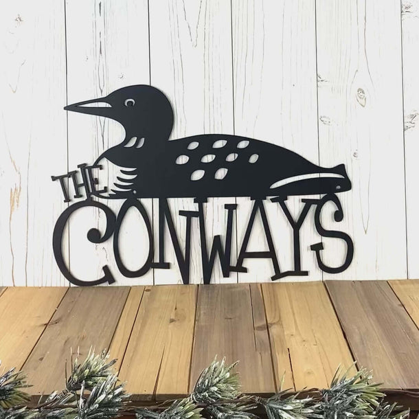 Video of personalized family name metal sign with lake loon, in matte black powder coat.
