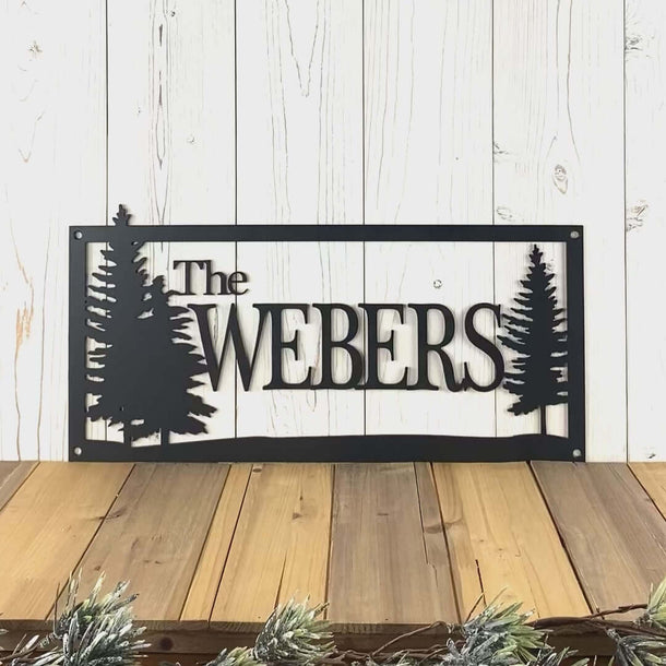 Video of custom family name metal sign, with pine trees, in matte black powder coat.