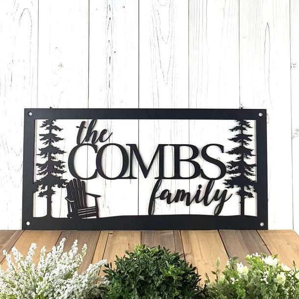 Video of Cabin family name metal sign with Adirondack Chair and pine trees, in matte black powder coat.