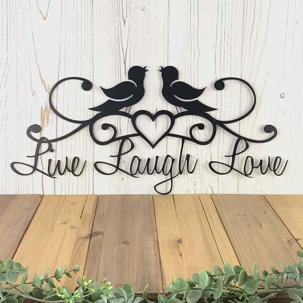 Video of Live Laugh Love metal wall art with love birds and heart, in matte black powder coat.