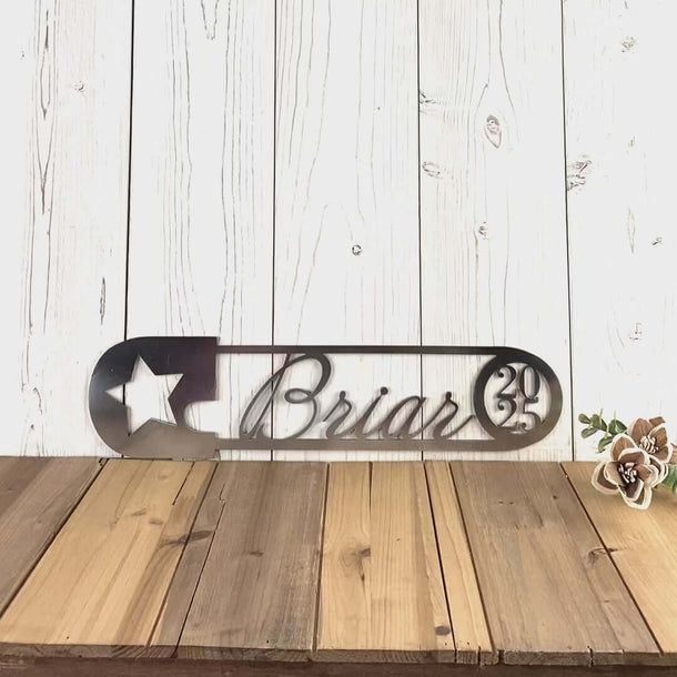 Personalized newborn infant boy or girl name and birth year saftety pin metal sign with star, in raw steel.