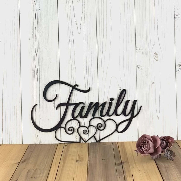 Video of cursive family metal wall art with three intertwining hearts, in matte black powder coat.