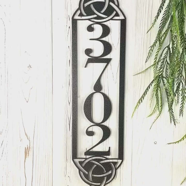 Video of vertical metal house number sign with Celtic knots, in silver vein powder coat.