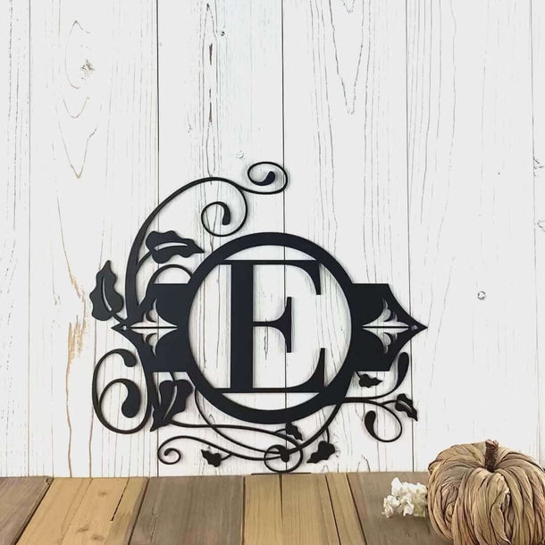 Video of round metal monogram sign with vines and fleur-de-lis, in matte black powder coat.