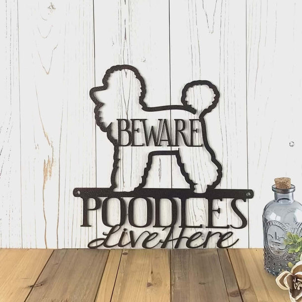 Video of Poodles live here metal wall art, with beware, in copper vein powder coat.