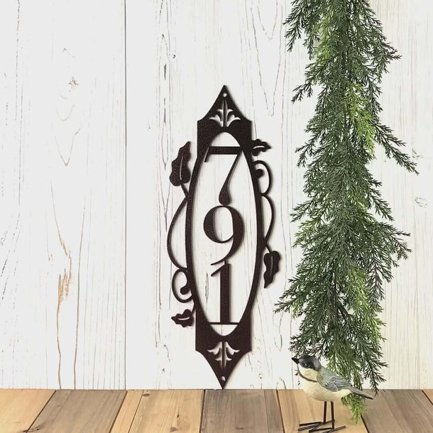 Video of vertical metal house number sign with vines and fleur-de-lis, in copper vein powder coat.