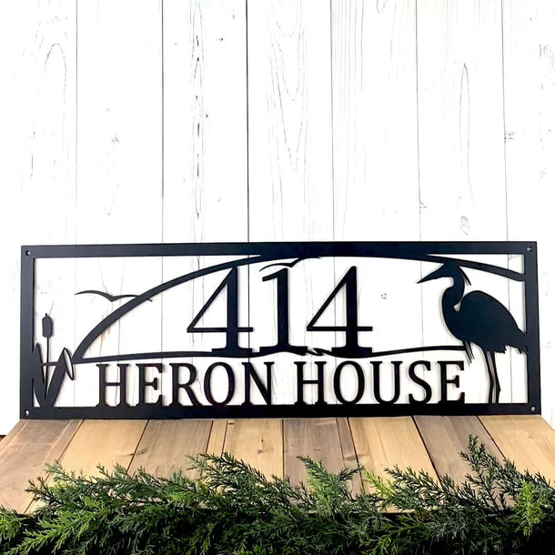 Personalized metal address sign with great blue heron bird and lake scene, in matte black powder coat.