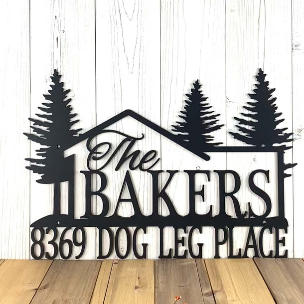Video of Lake Cabin family name and address metal sign with pine trees and cabin, in matte black powder coat.