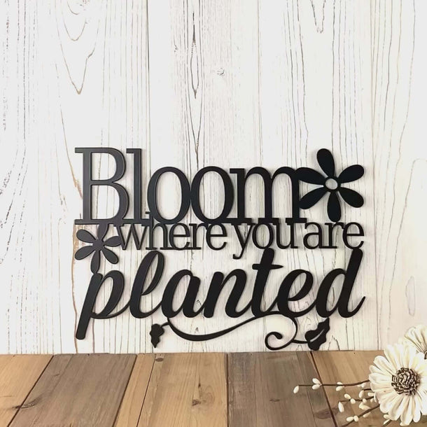 Video of Bloom Where You are Planted metal wall art, with flowers and vines, in matte black powder coat.