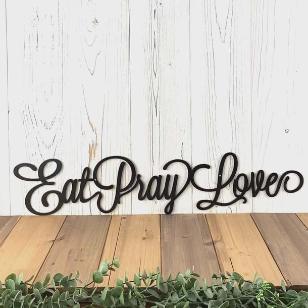 Video of script Eat Pray Love metal wall art, in matte black powder coat.