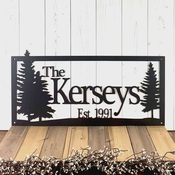 Video of personalized family name and established year metal sign, with pine trees, in matte black powder coat.