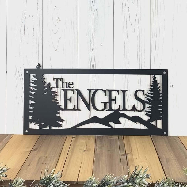 Video of personalized family name metal sign with mountains and pine trees, in matte black powder coat.