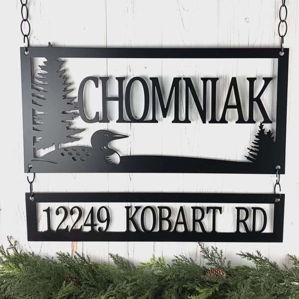 Video of custom family last name metal sign with loon and pine trees lake scene, in matte black powder coat.