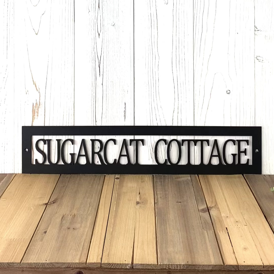 Hanging rectangular personalized cottage name metal sign, in matte black powder coat.
