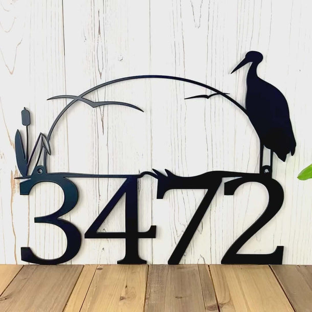 Video of personalized metal house number sign with heron and cattails lake scene, in matte black powder coat.