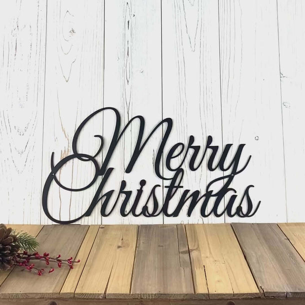 Video of Script Merry Christmas metal wall art, in matte black powder coat.
