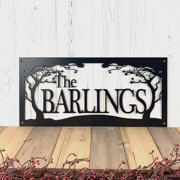 Video of custom family last name metal sign with cherry trees, in matte black powder coat.