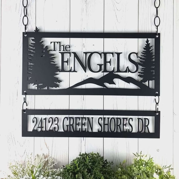 Video of personalized family name and address signs with mountains and pine trees, in matte black powder coat.