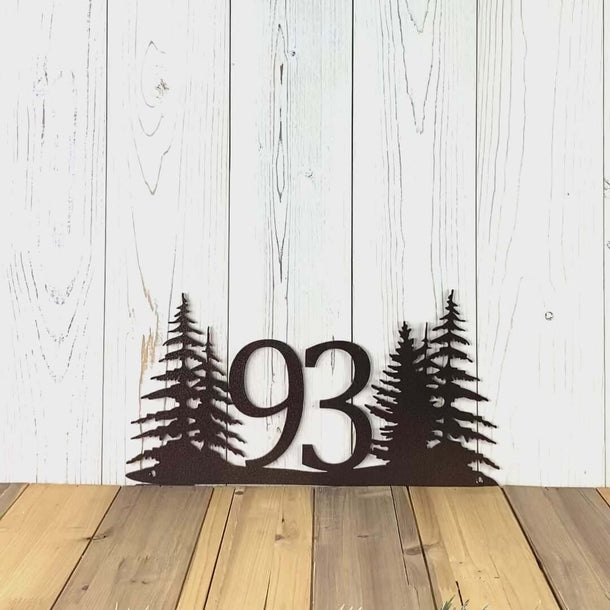 Video of horizontal metal house number sign with pine trees, in copper vein powder coat.