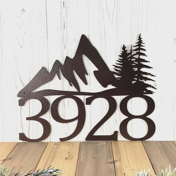 Video of personalized metal house number sign with mountains and pine trees, in copper vein powder coat.