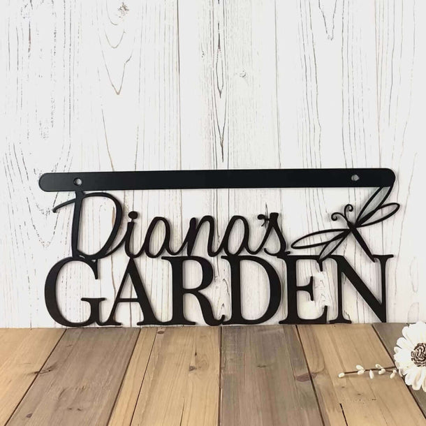 Video of personalized hanging garden name metal sign with a dragonfly, in matte black powder coat.