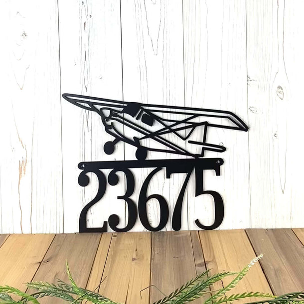 Video of airplane metal house number sign, in matte black powder coat.