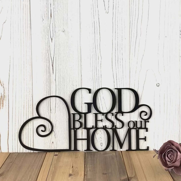 Video of God Bless Our Home metal sign with heart and scrolls, in matte black powder coat.