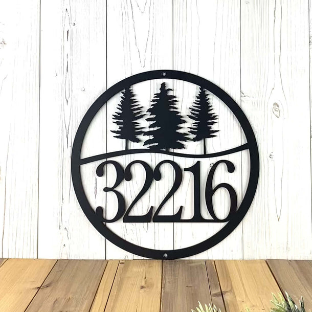 Video of round metal house number sign with pine trees, in matte black powder coat.