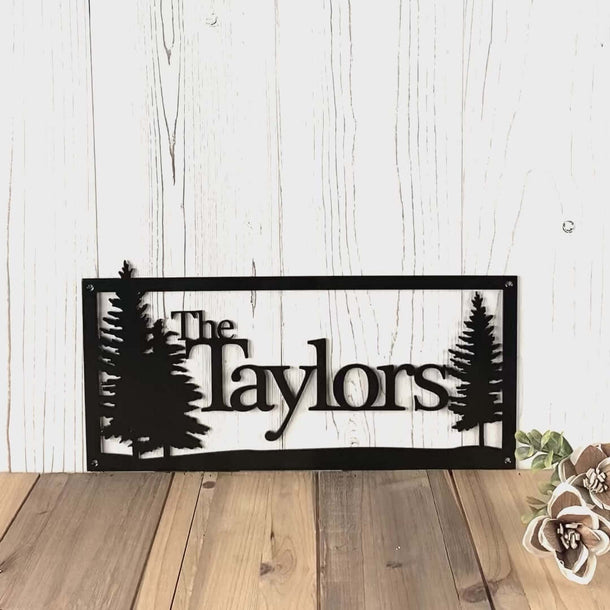 Video of Personalized family name sign with pine trees, in matte black powder coat.