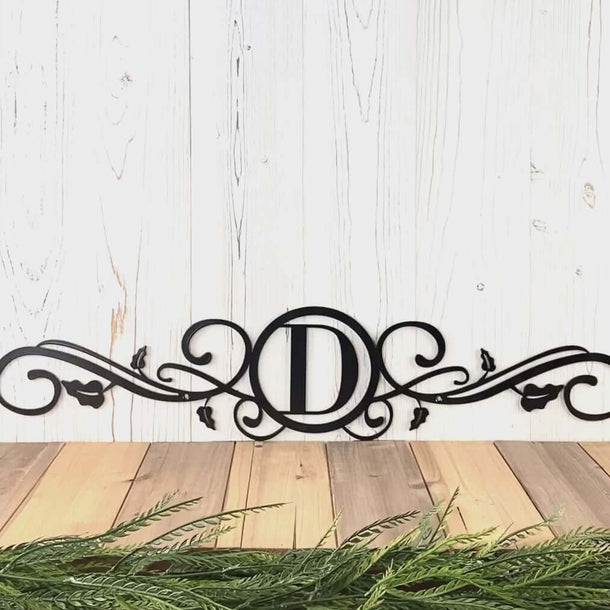 Video of metal monogram sign with scrollwork and vines, in matte black powder coat.