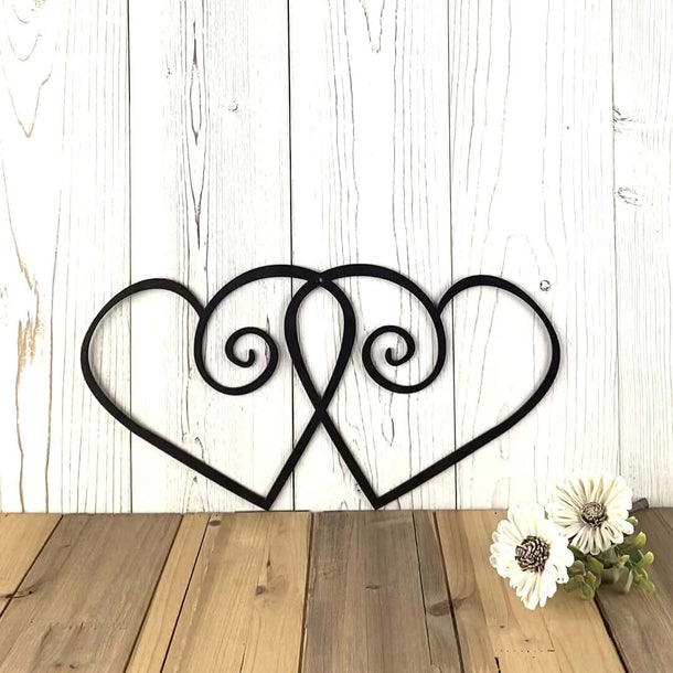 Video of intertwining hearts metal wall art, in matte black powder coat.
