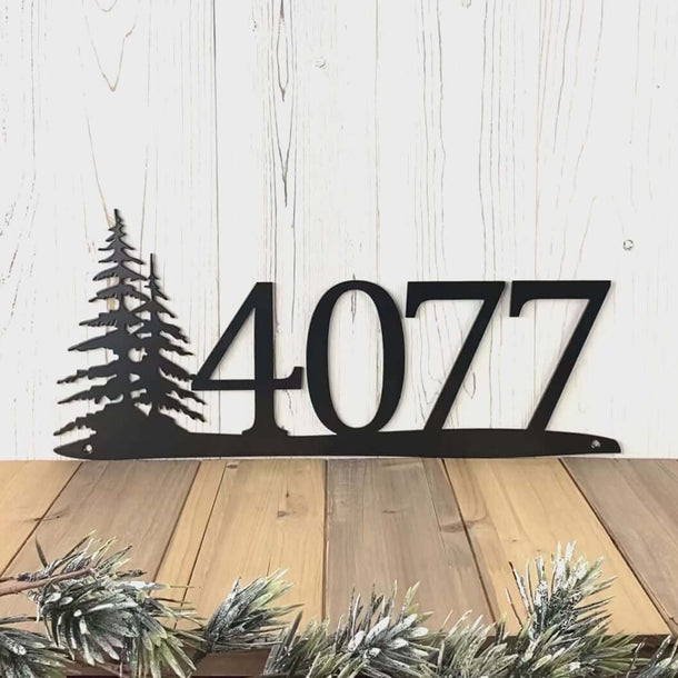 Video of horizontal metal house number sign with pine trees, in matte black powder coat.