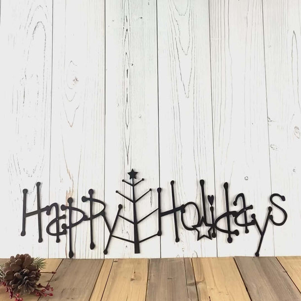 Video of Happy Holidays metal wall art with spindly Christmas tree, in matte black powder coat.